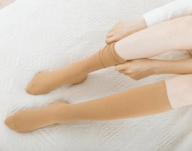 Person putting on compression stockings