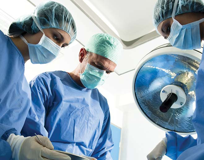 Surgical team working under operating light