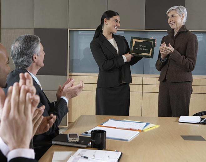 Colleague presenting service award during meeting
