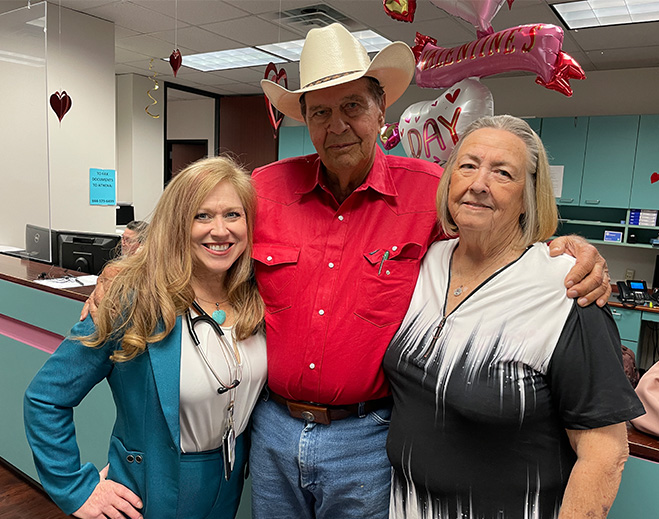 Three people posing at decorated clinic