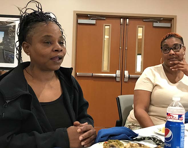 Community members seated at group discussion table
