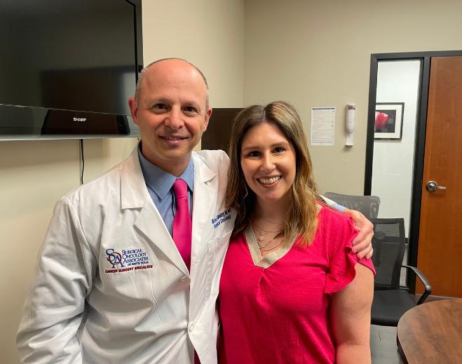 Clinician standing with patient in exam room