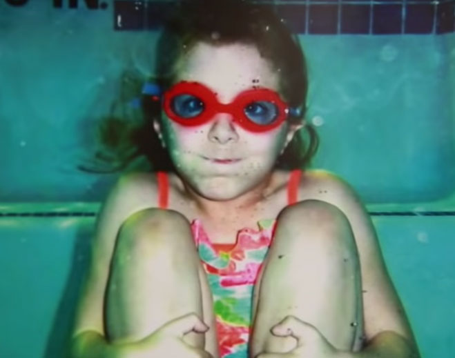 Child underwater wearing swim goggles