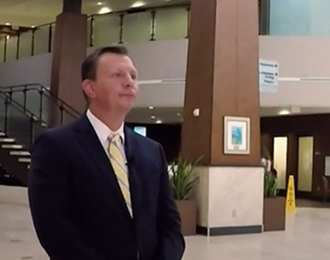 Professional standing in hospital lobby area