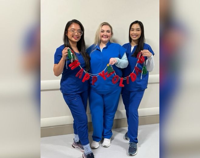 Medical staff holding holiday banner