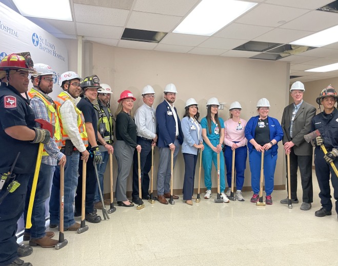 Group wearing hard hats at ceremony