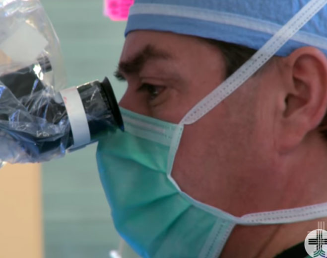 Medical professional using surgical microscope