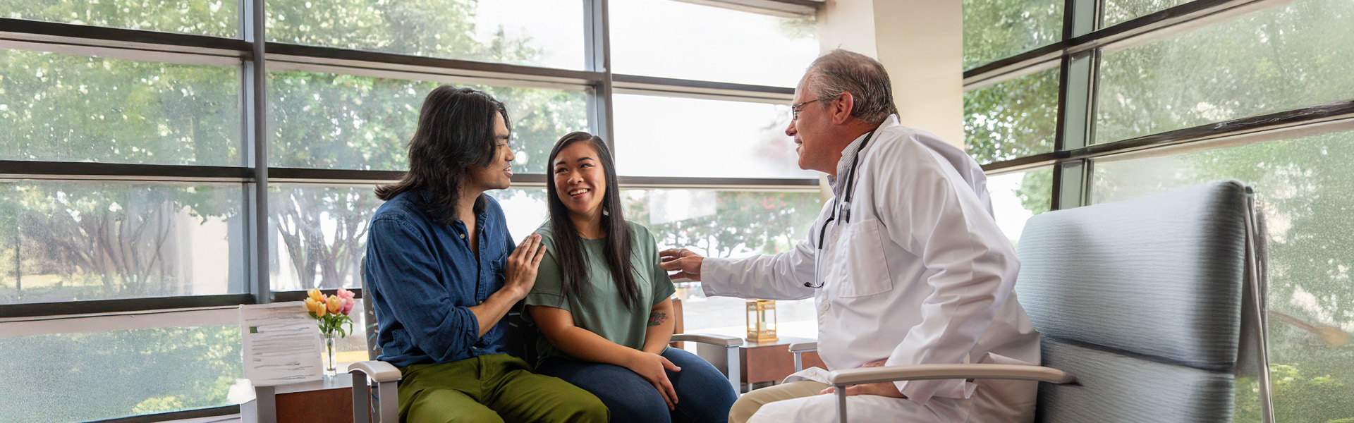 Doctor speaking with family during consultation