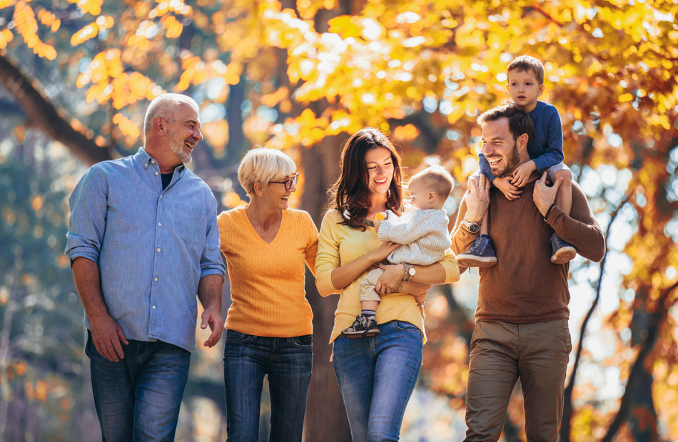Family walking together in autumn park