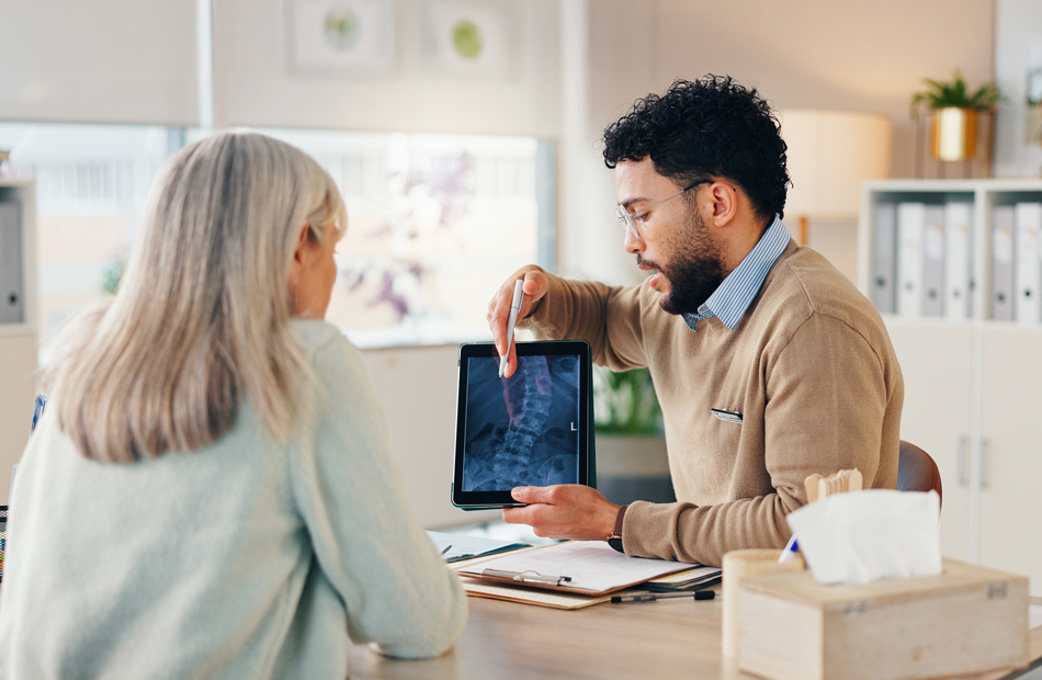 Healthcare provider reviewing spinal X-ray