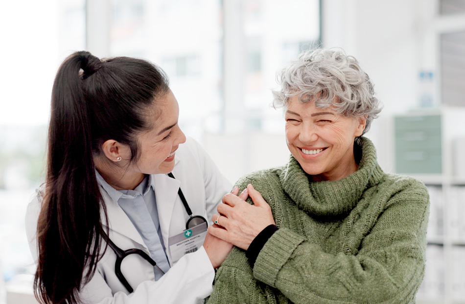 A doctor holds a tablet computer and discusses medical care options with a patient