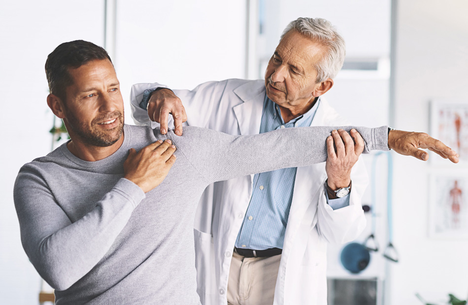 Clinician evaluating patient’s shoulder mobility