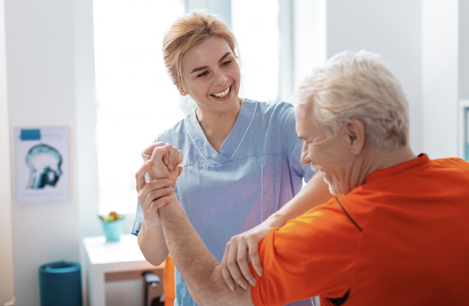 Clinician assisting individual with arm mobility