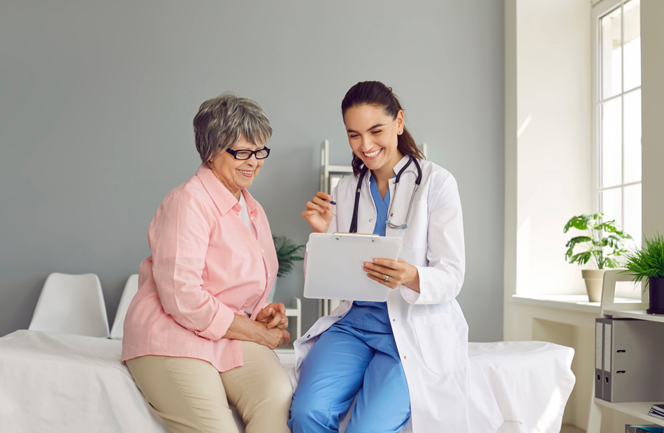 Clinician reviewing notes with patient in exam room