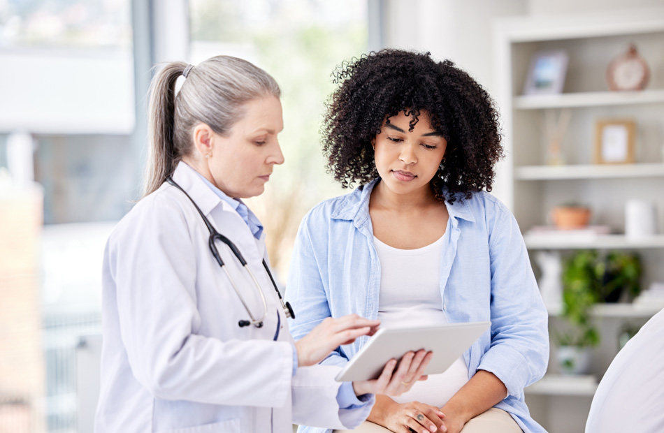 Clinician showing medical information on tablet