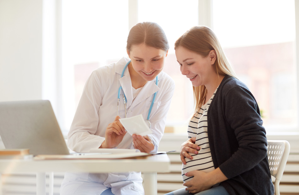 Doctor discussing results with pregnant patient
