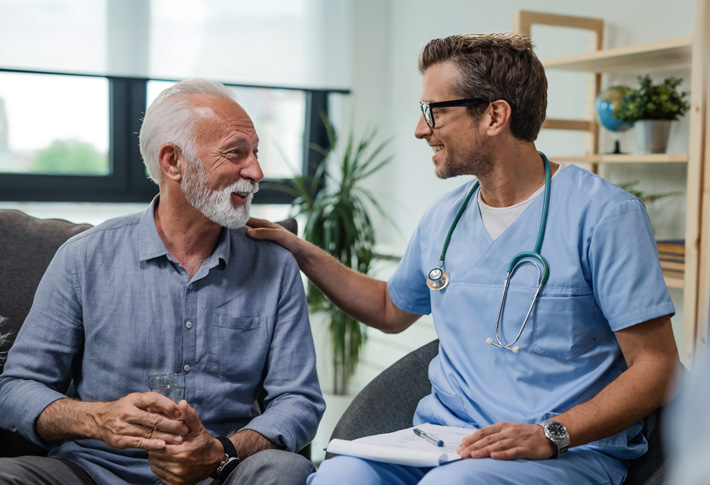 Healthcare professional comforting seated patient