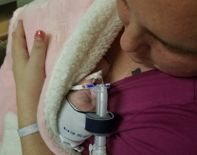 Calais Newman is pictured holding her micro-preemie
